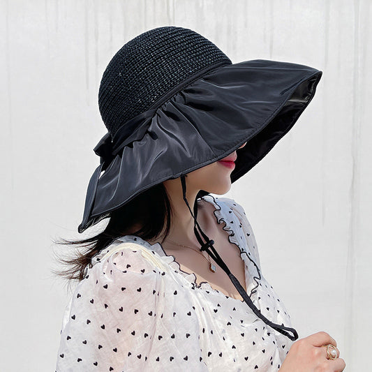 Woman wearing open-top cotton sun visor with bow detail outdoors in summer