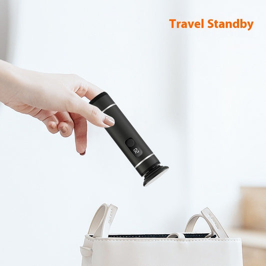 Hand holding a black travel