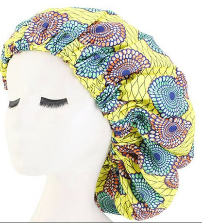 Colorful patterned headscarf on a mannequin head with a plain white background