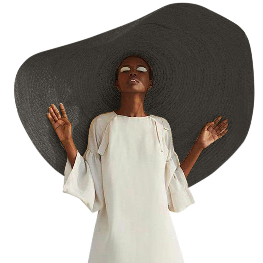  Close-up of warp-knit straw texture on a large-brim women's fashion hat in neutral black