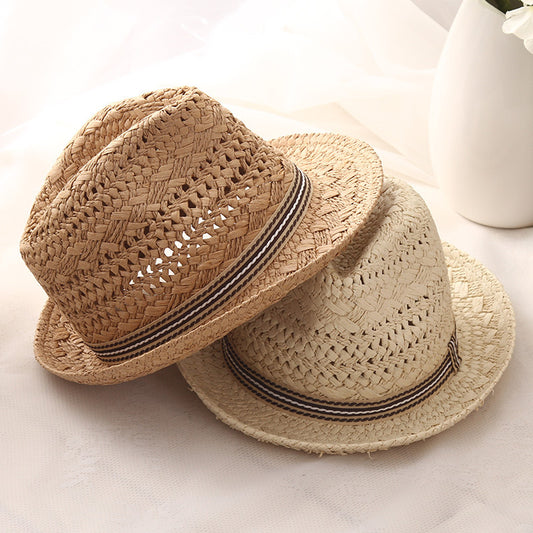 Mother and child wearing matching straw sun hats outdoors on a sunny day