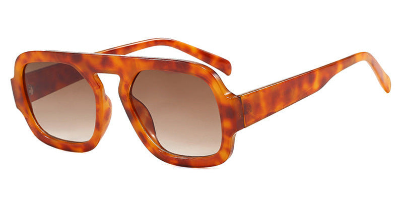 Sunglasses with tortoiseshell frame and brown lenses on a white background