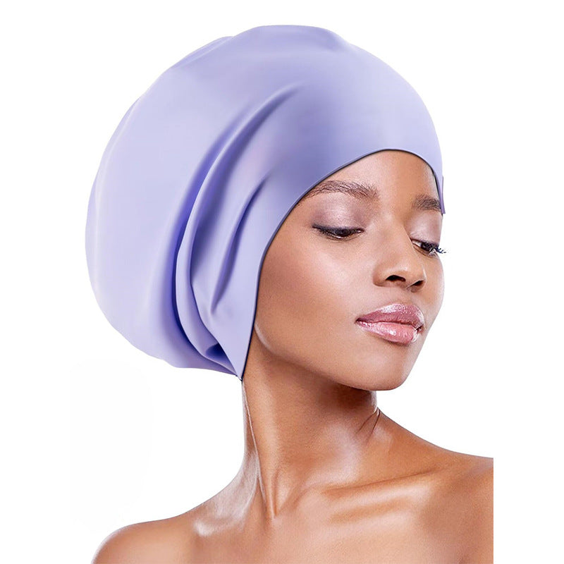 Extra-large waterproof silicone swimming cap designed to fully cover hair and protect ears, featuring a non-squeezing head fit for comfort during swimming