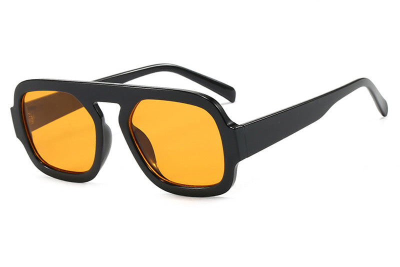 Black sunglasses with orange lenses on a white background