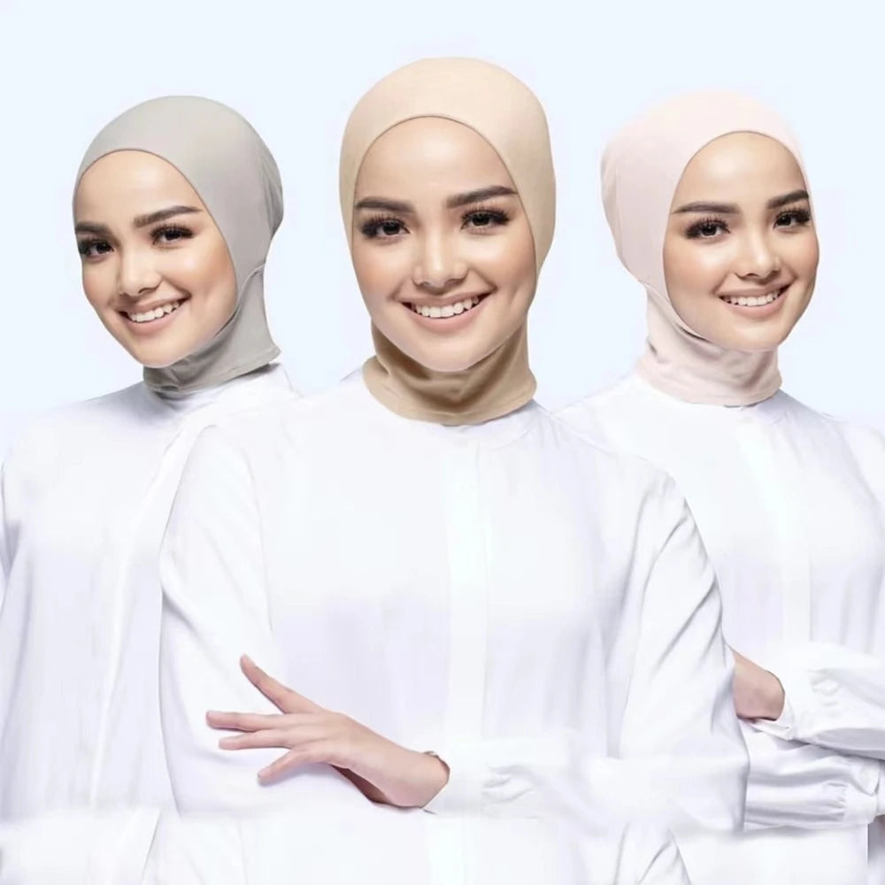 Three women wearing hijabs in beige, cream, and light pink against a white background