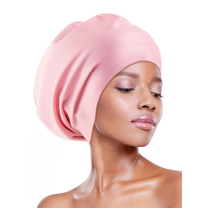 Extra-large waterproof silicone swimming cap designed to fully cover hair and protect ears, featuring a non-squeezing head fit for comfort during swimming