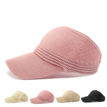 Pink knit cap on a white background with additional caps in different colors displayed below.
