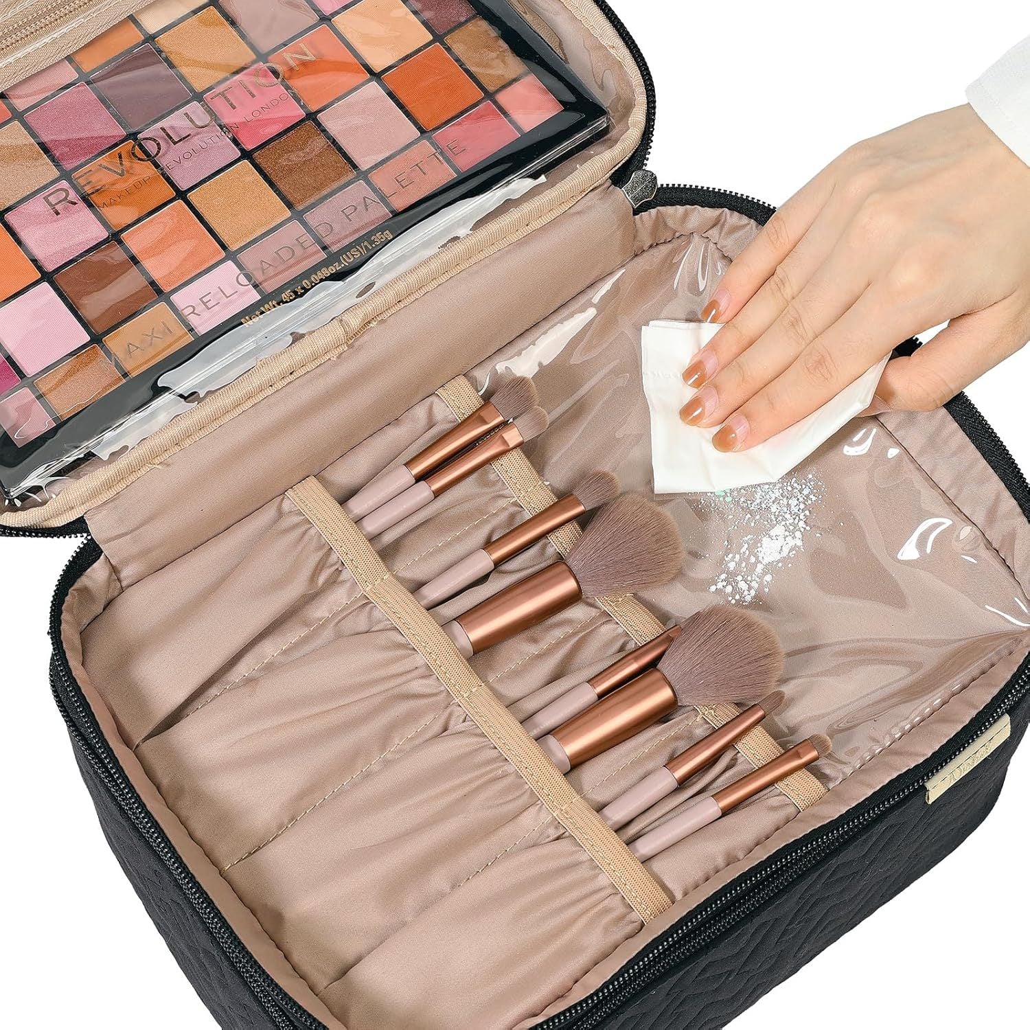 Makeup brushes in a case with a hand holding a tissue, next to a makeup palette.