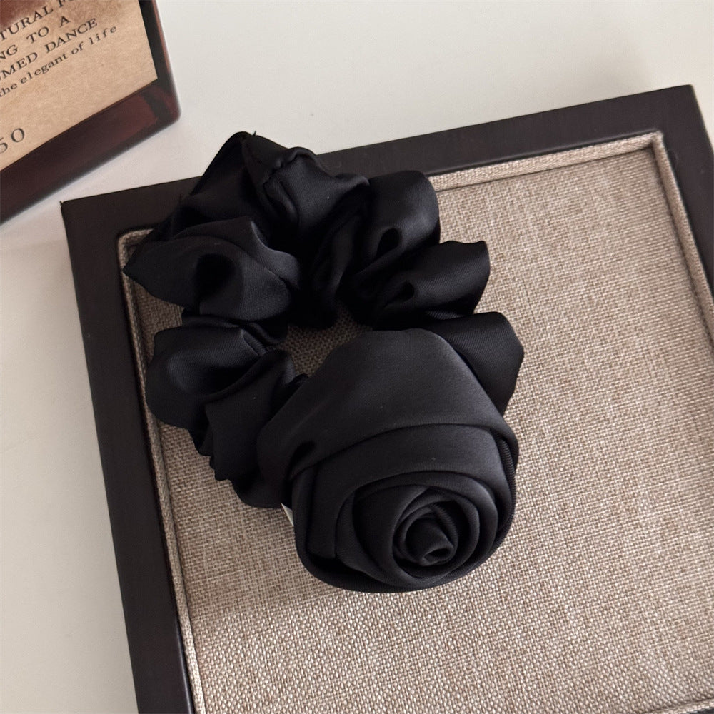 Black scrunchie on a textured surface