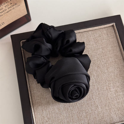 Black scrunchie on a textured surface